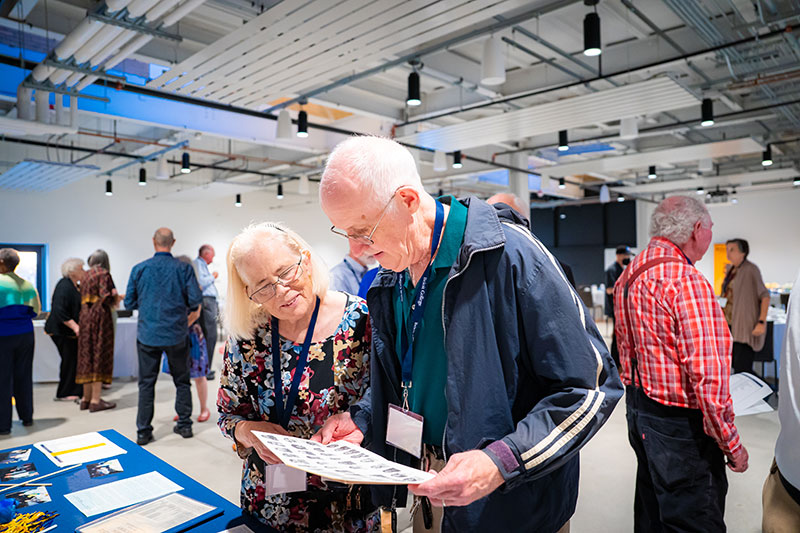 An older couple looking at a booth. An older couple looking at a booth.