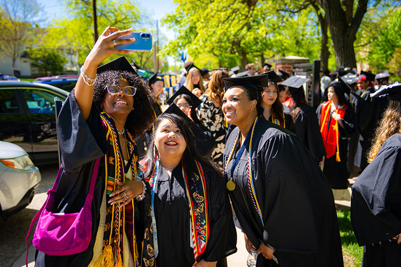 Students taking a selfie together. Links to What to Give Students taking a selfie together. Links to What to Give