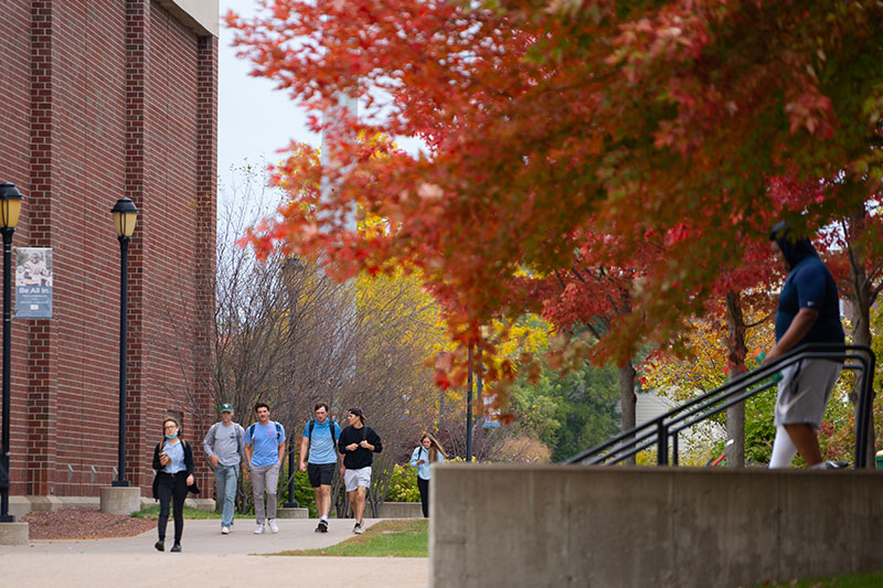 Students walking on campus. Links to Closely Held Business Stock