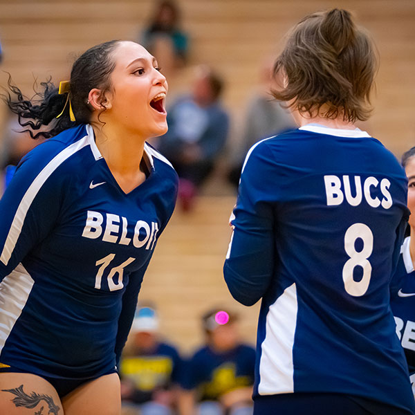 Two girls heckling each other during a sports game